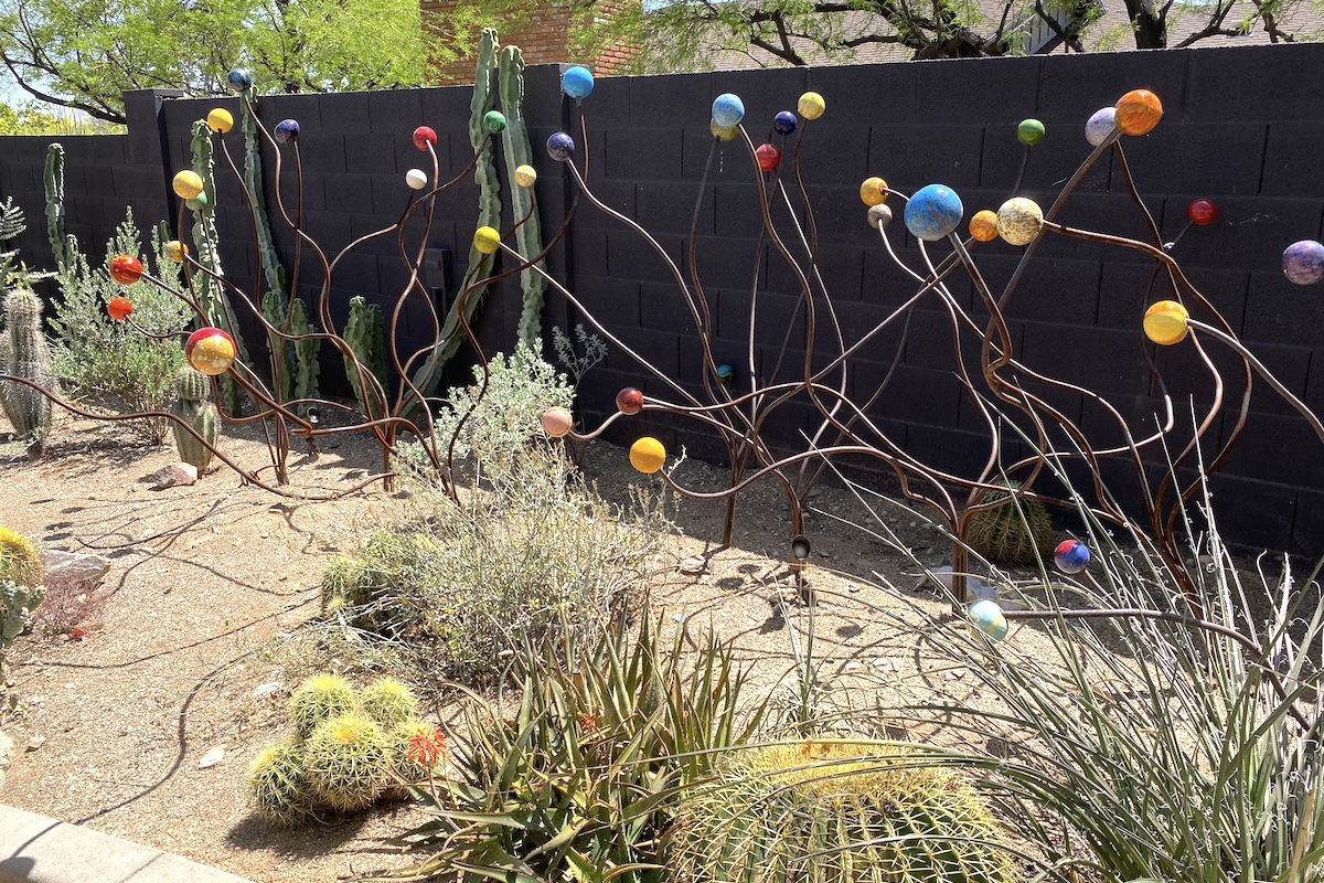 Ceramic balls atop rebar in Janet Orr's garden (c) Debra Lee Baldwin