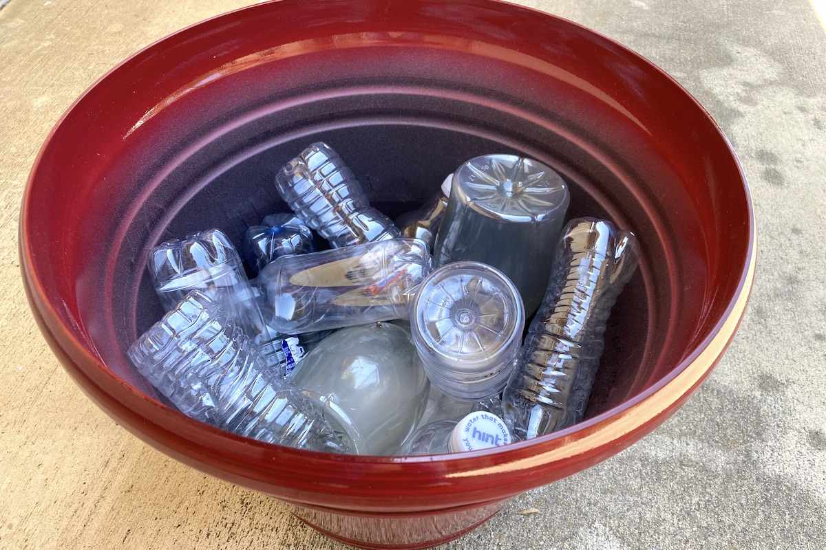 Make flowerpots lighter in weight by filling halfway with capped plastic bottles.